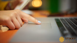 Pointer finger on laptop trackpad running PPC Ad Campaign